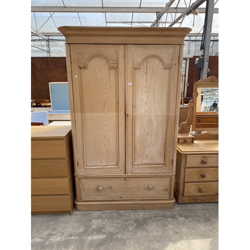A VICTORIAN PINE ARCHED TWO DOOR WARDROBE WITH DRAWER TO BAS...