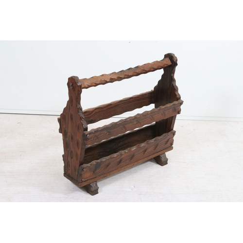 20th century stained pine magazine rack, having knotched sid...
