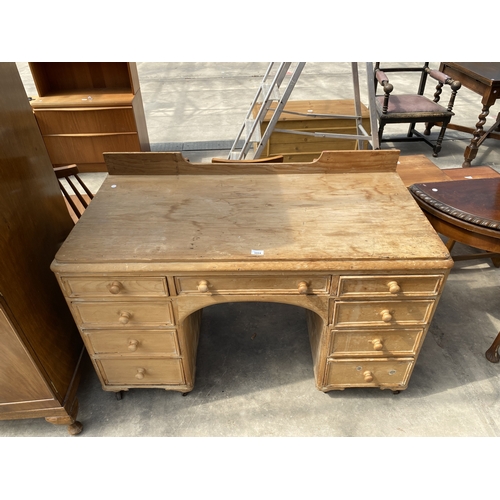 A VICTORIAN PINE TWIN PEDESTAL DESK ENCLOSING NINE DRAWERS, ...