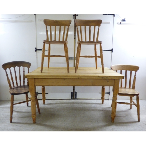 A 20thC pine farmhouse table, raised on turned legs  29...