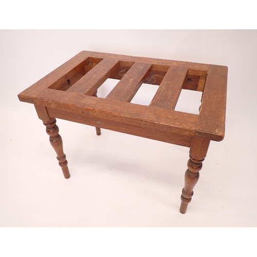 An early 20th century pine slatted luggage stand, 63cm wide
