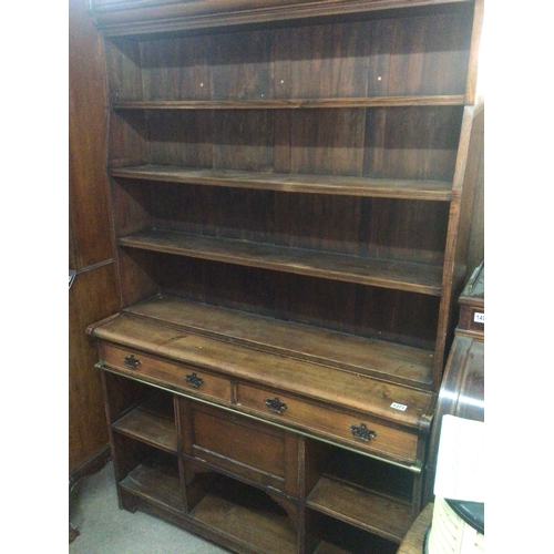 An Edwardian stained pitch pine and oak open bookcase with f...