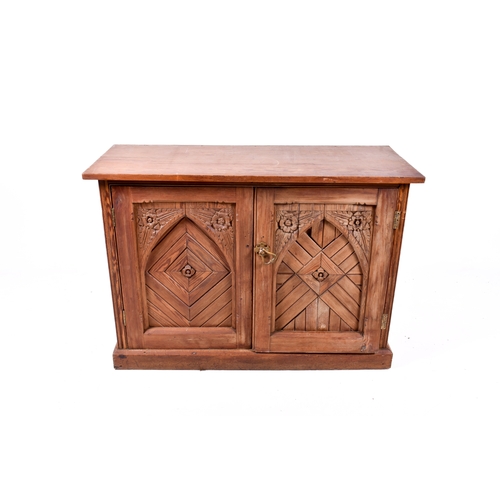 A Victorian pitch pine two door cupboard (af). Having carved...