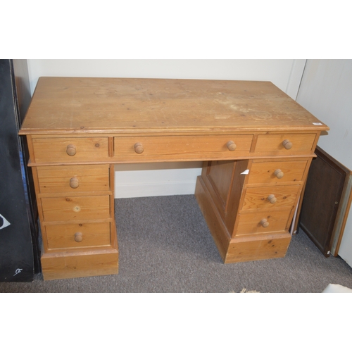 Pine pedestal nine drawer kneehole desk.