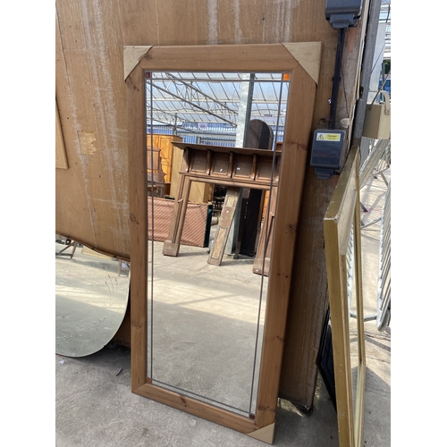 A PINE FRAMED AND LEADED WALL MIRROR, 66" X 30"