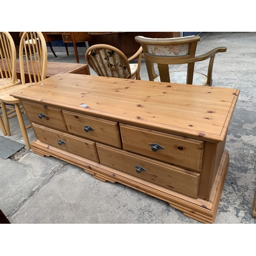 A LOW PINE CHEST OF THREE SHORT AND TWO LONG DRAWERS, 59" WI...