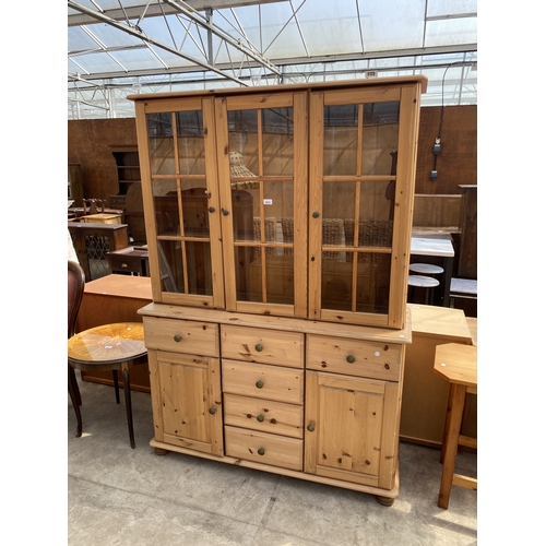 A PINE DRESSER WITH THREE DOOR GLAZED UPPER PORTION WITH FIV...