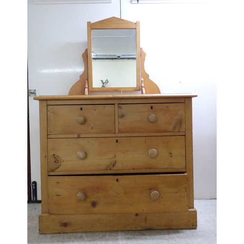 A late Victorian pine four drawer dressing chest, surmounted...
