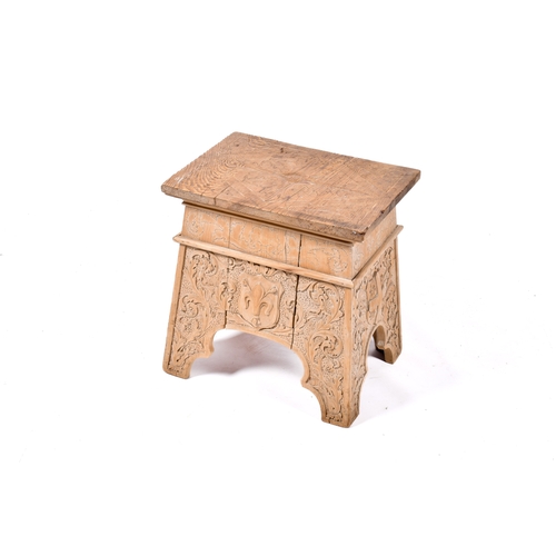 A carved pine stool with fleur-de-lis and scrolling foliage ...