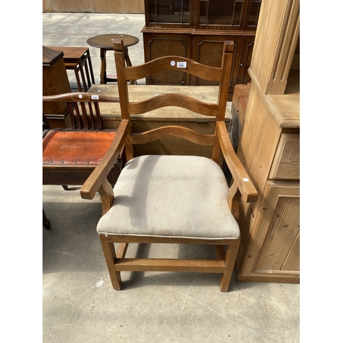 A PINE ARM CHAIR WITH SHAPED LADDER BACK