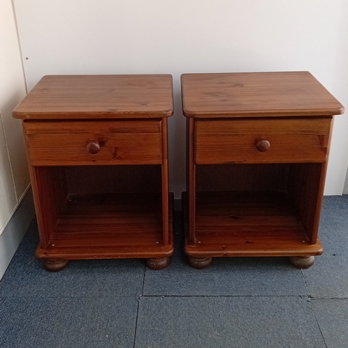A pair of pine bedside cabinets, each with a moulded rectang...