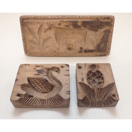 Three antique carved treen biscuit moulds with swan, cow, pi...