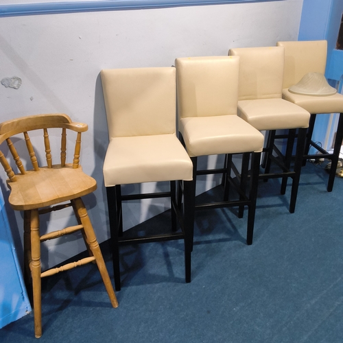 Four cream bar stools and a pine high chair