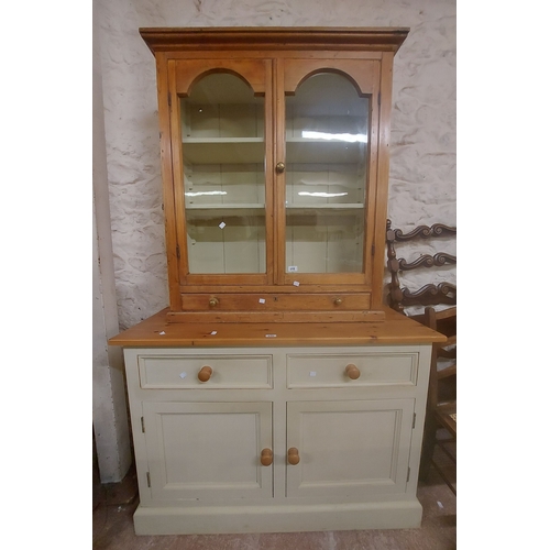 A 93cm Victorian pine cabinet with two glazed doors over sin...