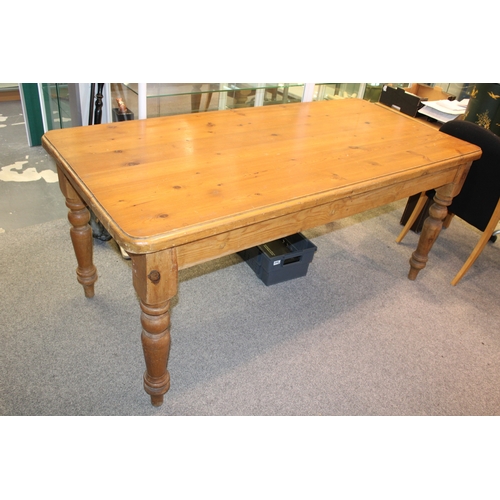 A mid 20th century pine farmhouse table with single drawer t...