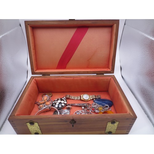 A stained pine jewellery box with applied brass banding,  co...