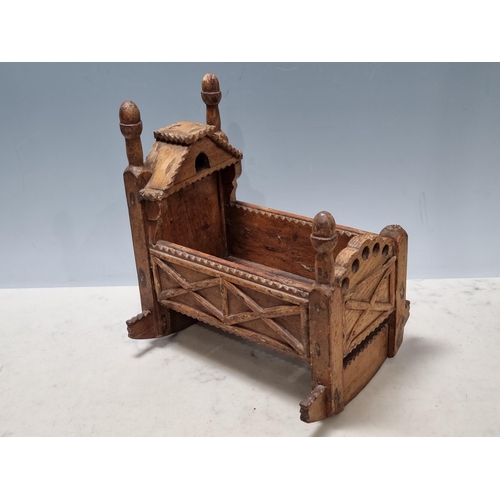 An 18th Century pine Folk Art Doll's Cradle with chip carved...