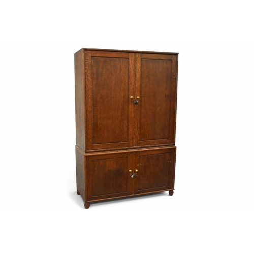 Large mid-20th century oak two section storage cupboard with...