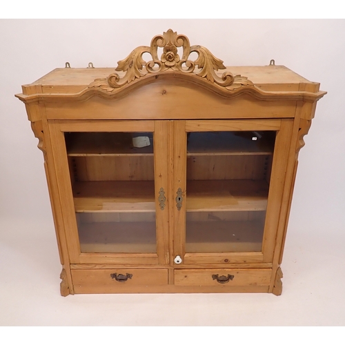 A continental pine wall cabinet with two glazed doors enclos...