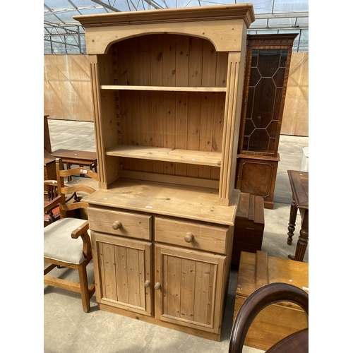 A PINE KITCHEN DRESSER WITH RACK, TWO DRAWERS AND TWO CUPBOA...