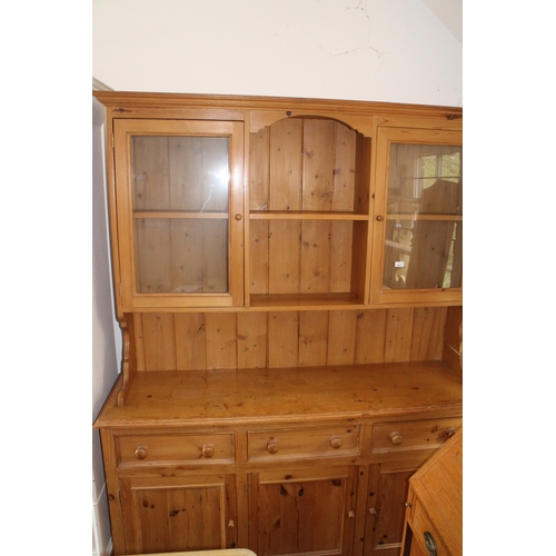 A waxed pine dresser, the upper section fitted shelves and t...