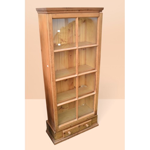 Pine display cabinet with single glazed door, three internal...