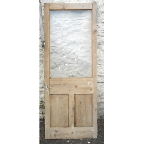 A pine door with central glass panel
