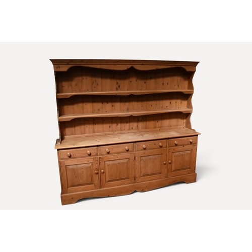 A large 20th century  pine kitchen dresser with plate rack a...
