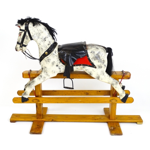 Toy: A 20thC wooden dapple grey rocking horse, with painted ...