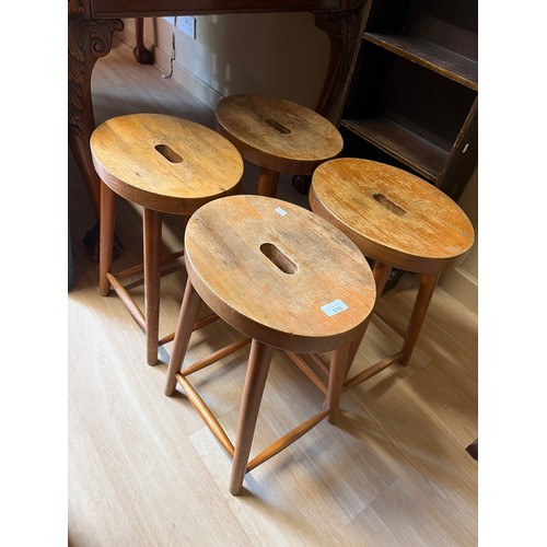 Set of four pine oval topped stools.