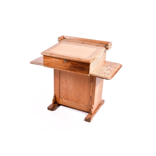 A pitch pine 'school' style desk. Having a hinged writing sl...