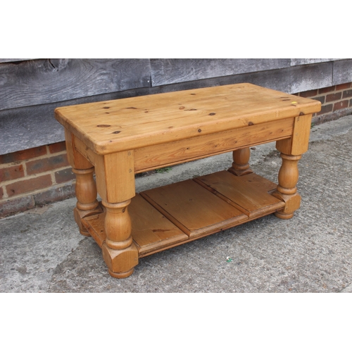 A waxed pine two-tier coffee table, 36" wide x 18" deep x 20...