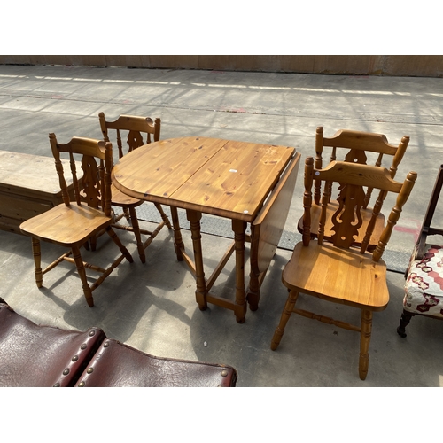 A PINE GATE LEG DINING TABLE ON TURNED LEGS AND FOUR PIERCED...