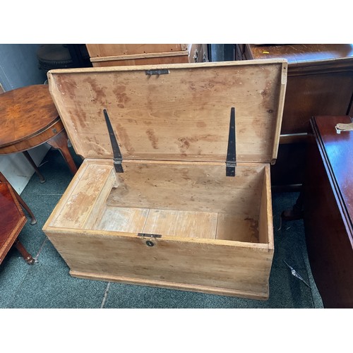 A Victorian pine trunk with cast iron handles and key with i...