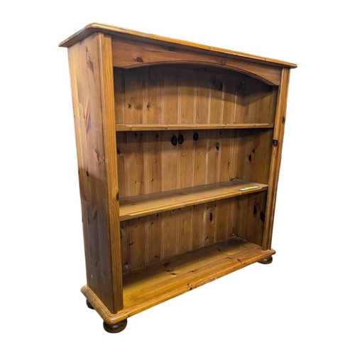 A later 20th century solid pine open window bookcase. The bo...