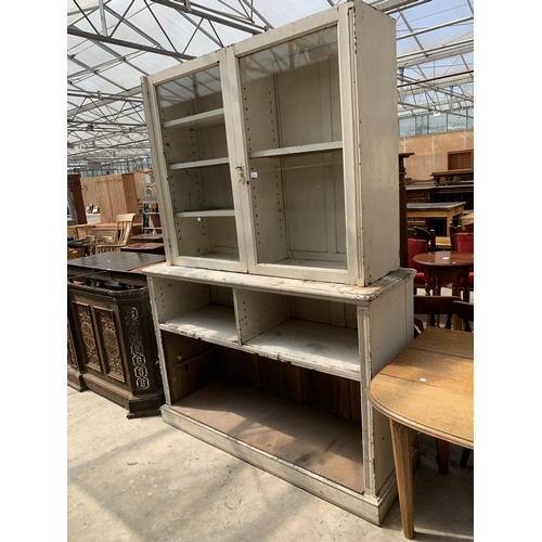 A WHITE PAINTED PINE TWO DOOR GLAZED BOOKCASE ON OPEN BASE, ...