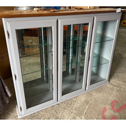 Large painted display cabinet fitted with three glazed doors...