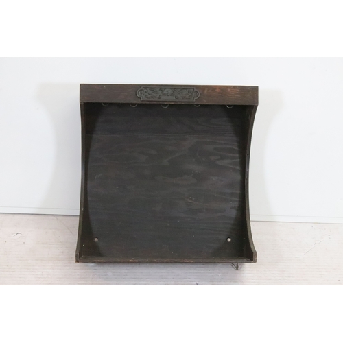 20th century stained pine hanging rack, with cast iron plaqu...