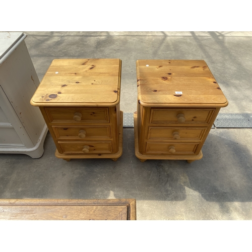 A PAIR OF PINE THREE DRAWER BEDSIDE CHESTS