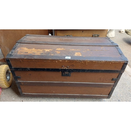 An 86cm antique dome topped trunk with wood banding - sold w...