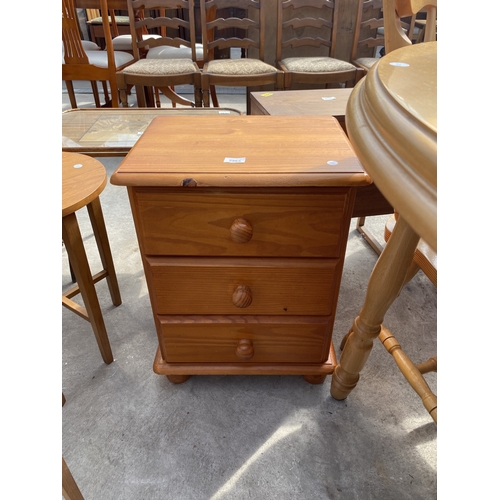 A PINE THREE DRAWER BEDSIDE CHEST