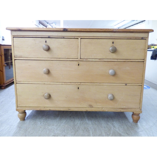 A Victorian pine four drawer dressing chest, raised on turne...