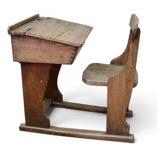 A Victorian pine school desk, integrated seat, slope hinged ...