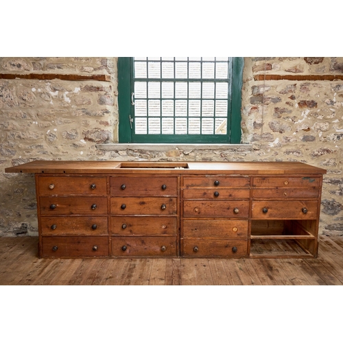 A TWO-PIECE STAINED PINE SHOP COUNTER WITH DARK STAINED KNOB...