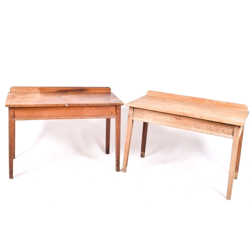 A pair of vintage pine work tables. Having a raised backs, m...
