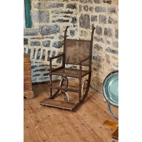 A STAINED PINE AND CANED BATH OR INVALID CHAIR A STAINED PIN...