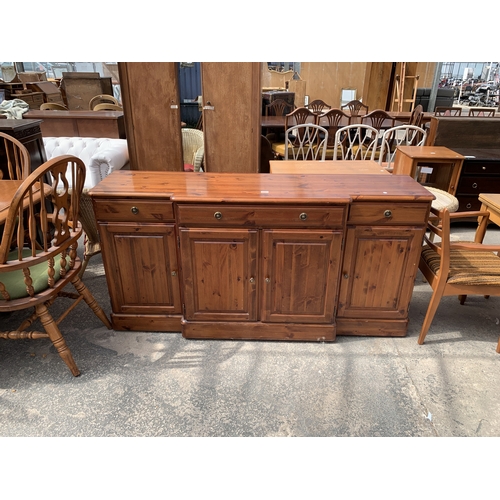 A DUCAL PINE BREAKFRONT SIDEBOARD ENCLOSING THREE DRAWERS AN...