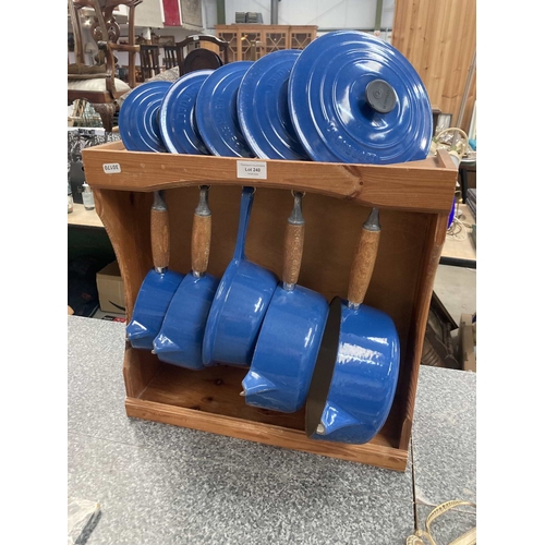 Le Creuset blue enamelled cast iron saucepans with lids on p...